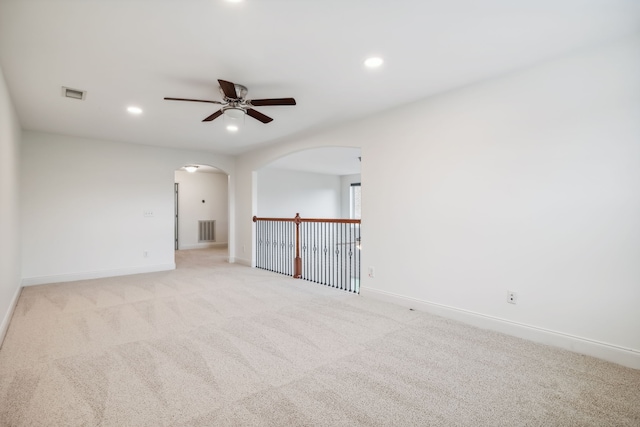 carpeted spare room with ceiling fan