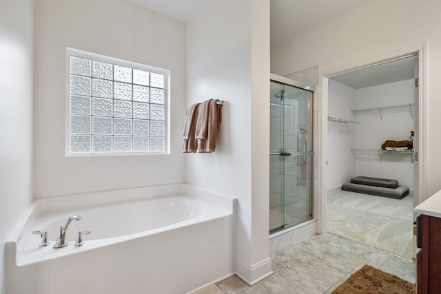 bathroom with vanity and independent shower and bath