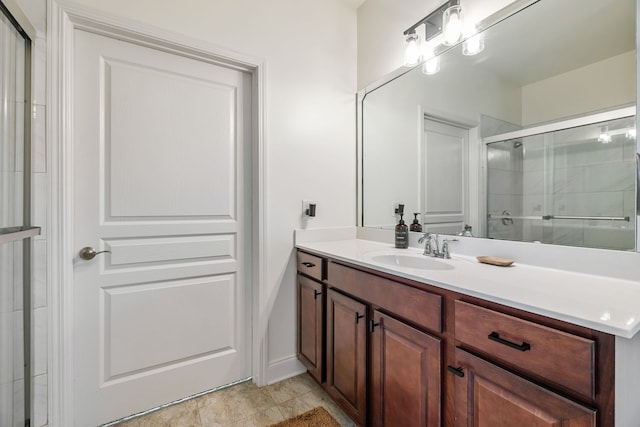 bathroom featuring tile patterned flooring, vanity, and walk in shower