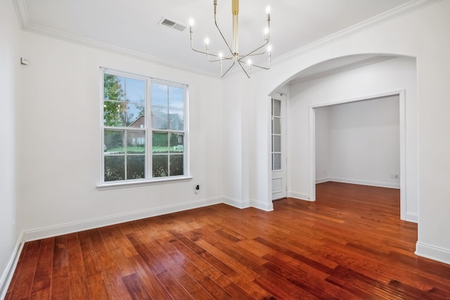 unfurnished room with wood-type flooring, ornamental molding, and a notable chandelier