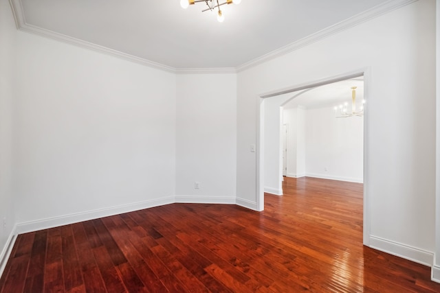 spare room featuring ornamental molding, a chandelier, and hardwood / wood-style flooring