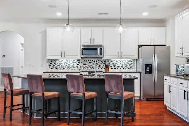 kitchen featuring pendant lighting, dark hardwood / wood-style floors, white cabinetry, and appliances with stainless steel finishes