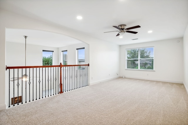 unfurnished room with carpet and ceiling fan