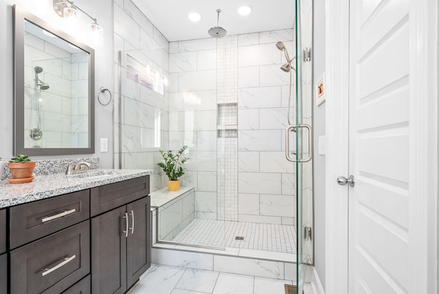 bathroom featuring vanity and a shower with shower door