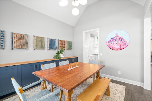 dining room featuring wood-type flooring and high vaulted ceiling