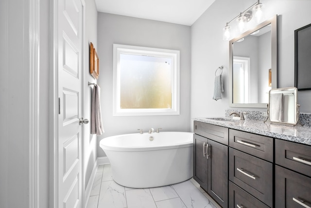 bathroom featuring vanity and a tub to relax in