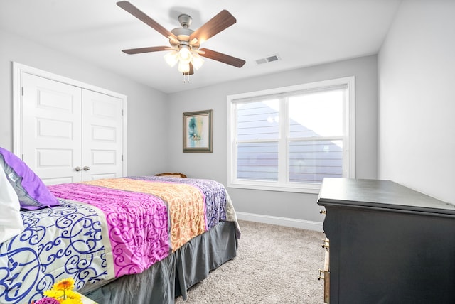 bedroom with ceiling fan, a closet, and carpet floors