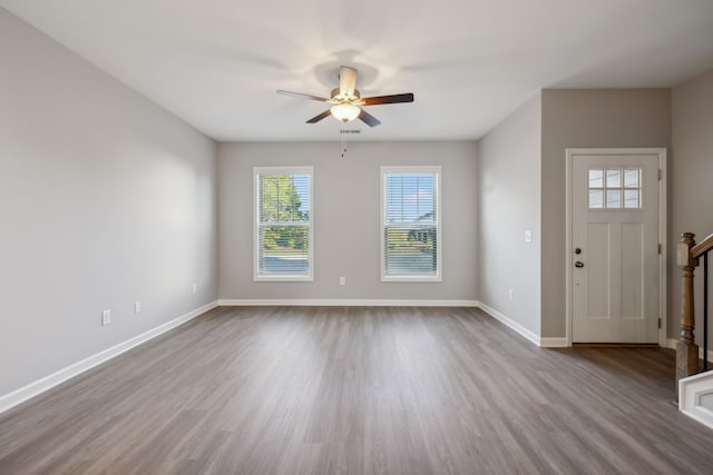 foyer with light hardwood / wood-style flooring and ceiling fan