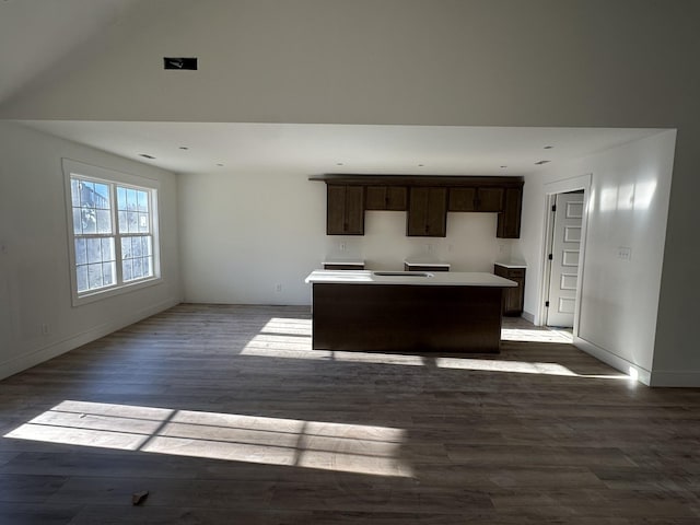 kitchen with hardwood / wood-style floors, a center island, and dark brown cabinets