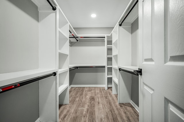 walk in closet with light wood-type flooring