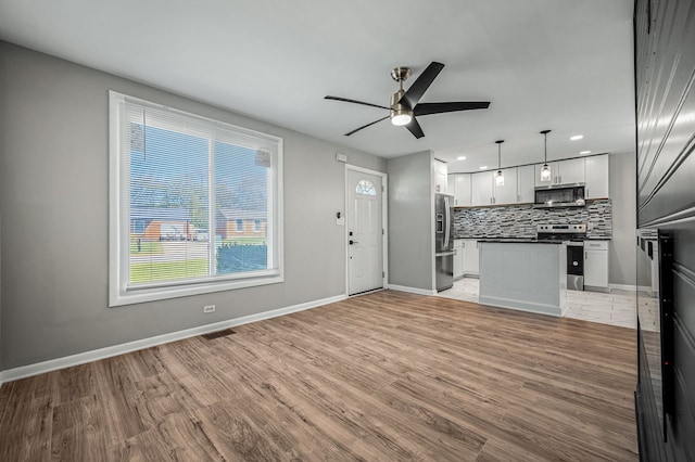 interior space featuring light hardwood / wood-style flooring and ceiling fan