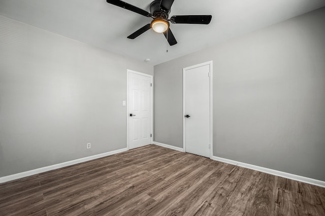 unfurnished room featuring ceiling fan and dark hardwood / wood-style floors