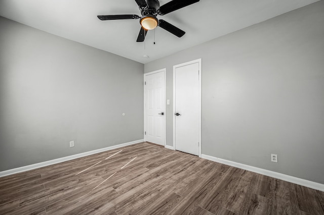 unfurnished bedroom featuring ceiling fan and hardwood / wood-style floors