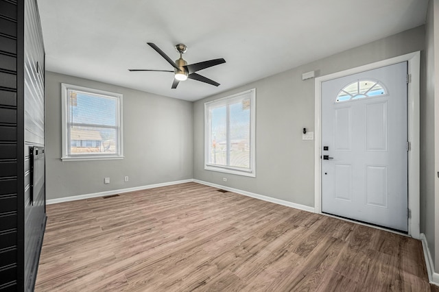 foyer entrance with ceiling fan, plenty of natural light, and light hardwood / wood-style floors