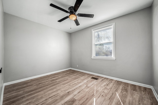 unfurnished room with hardwood / wood-style flooring and ceiling fan