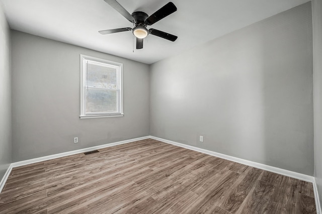 spare room featuring hardwood / wood-style flooring and ceiling fan