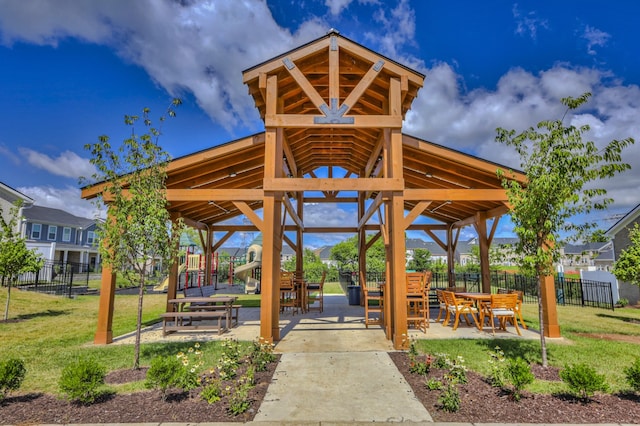 view of community featuring a playground, a gazebo, and a yard