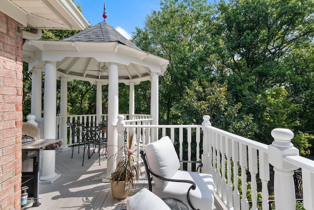 wooden terrace featuring a gazebo