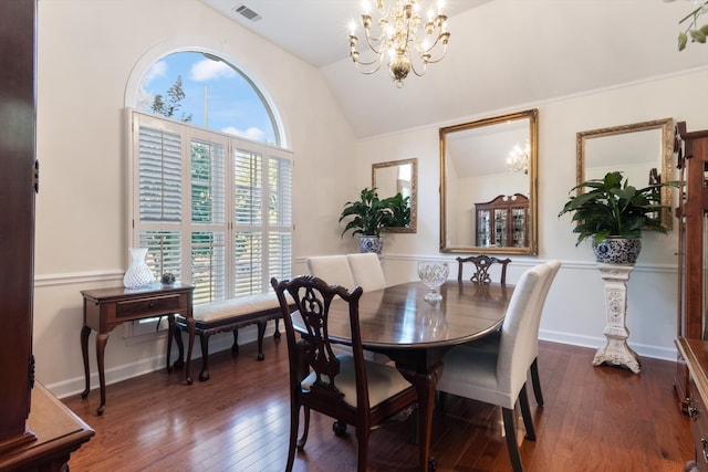 dining area with a chandelier, dark hardwood / wood-style floors, and vaulted ceiling