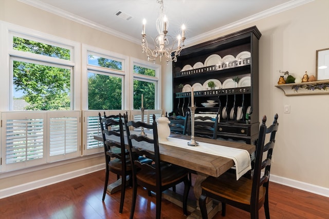 dining area with crown molding, dark hardwood / wood-style floors, and an inviting chandelier