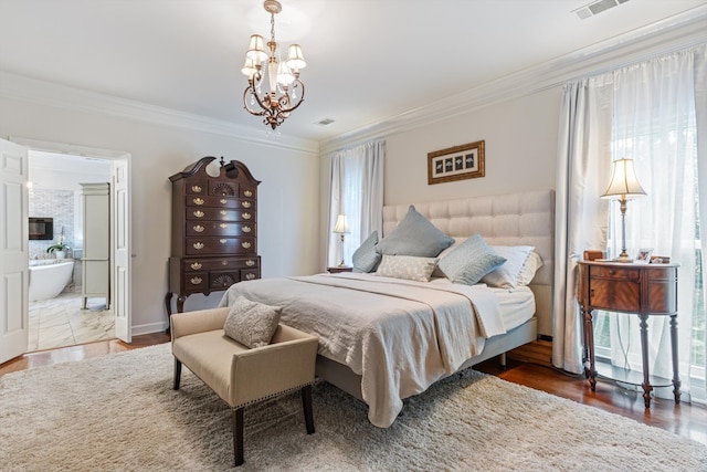 bedroom with connected bathroom, crown molding, hardwood / wood-style flooring, and an inviting chandelier