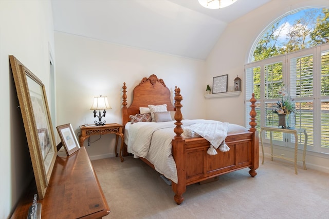 bedroom featuring vaulted ceiling, light carpet, and multiple windows