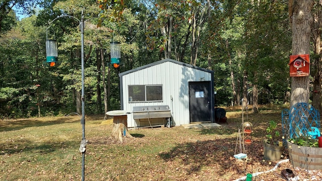 view of outbuilding featuring a lawn