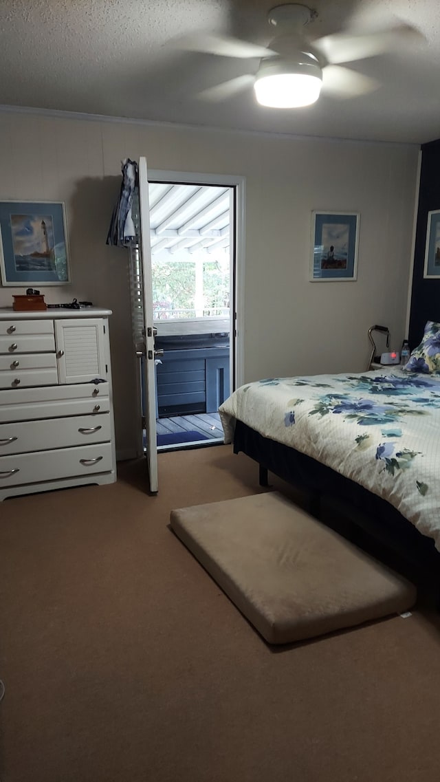 carpeted bedroom with ceiling fan and a textured ceiling