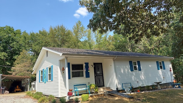 view of front of home with covered porch and a carport