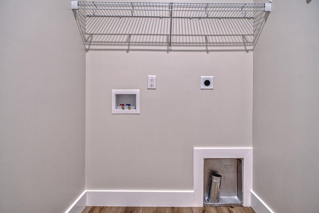 laundry area with hardwood / wood-style flooring, electric dryer hookup, and washer hookup