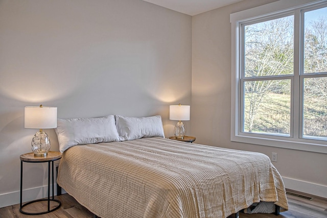 bedroom with wood-type flooring