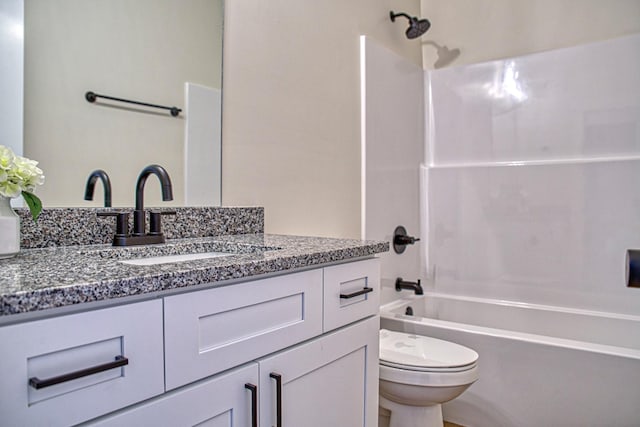 full bathroom featuring vanity,  shower combination, and toilet