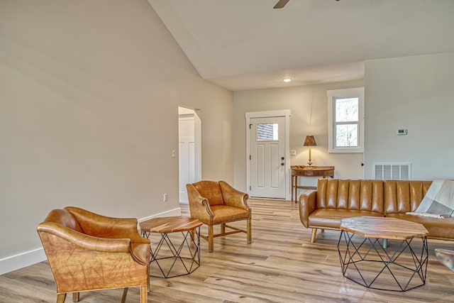 sitting room with light hardwood / wood-style flooring, ceiling fan, and lofted ceiling