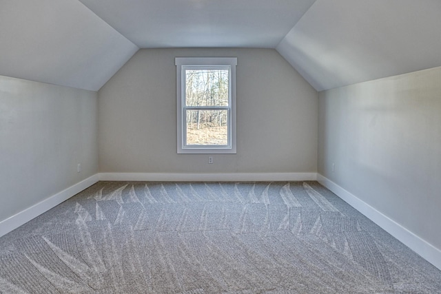 bonus room with carpet flooring and lofted ceiling