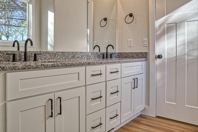 bathroom with hardwood / wood-style floors and vanity