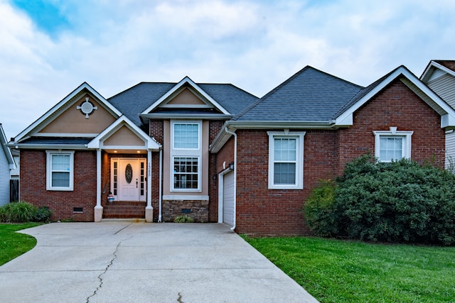 view of front of house featuring a front yard and a garage