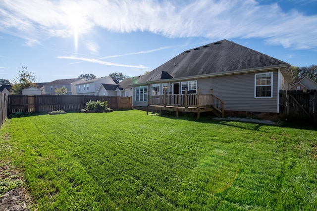 back of house featuring a lawn and a wooden deck