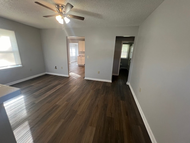 spare room with a healthy amount of sunlight and dark wood-type flooring