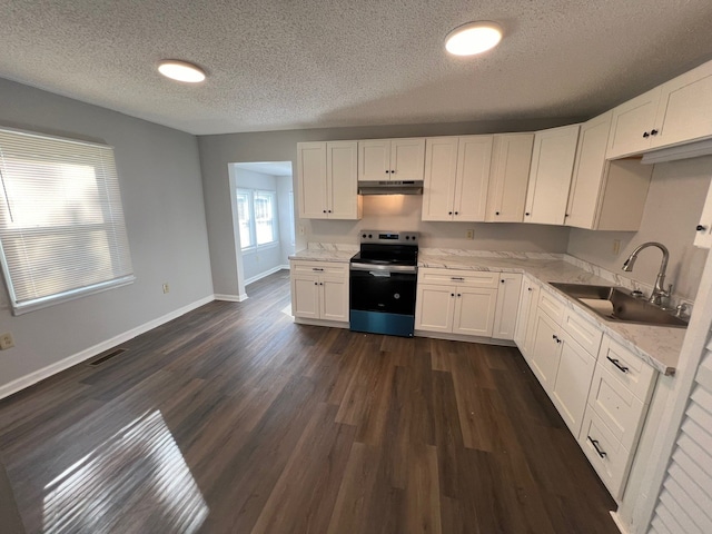 kitchen featuring electric range, sink, dark wood-type flooring, a textured ceiling, and white cabinets