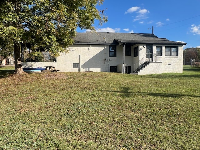 rear view of property with a lawn