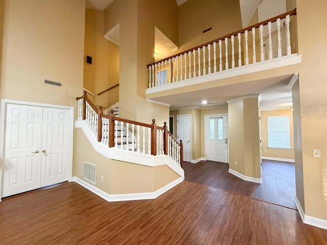 foyer with a high ceiling and dark hardwood / wood-style flooring