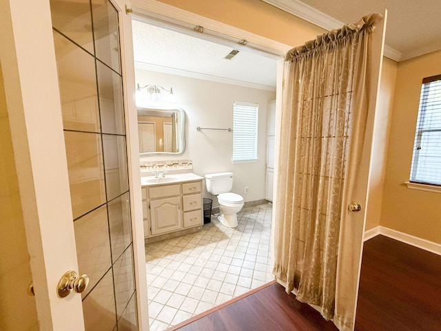 bathroom featuring hardwood / wood-style flooring, vanity, toilet, and crown molding