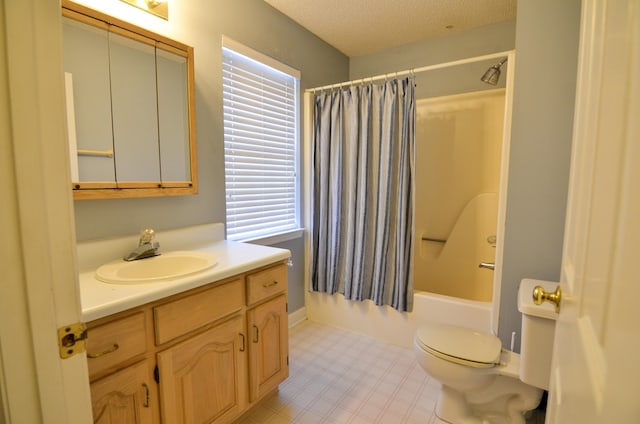 full bathroom with shower / bath combination with curtain, vanity, a healthy amount of sunlight, and a textured ceiling