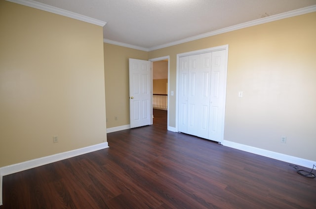 unfurnished bedroom featuring a textured ceiling, dark hardwood / wood-style floors, a closet, and crown molding