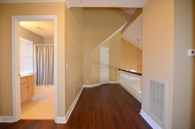 hall featuring dark hardwood / wood-style flooring and a textured ceiling