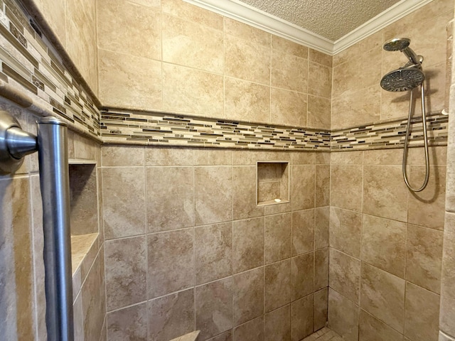 bathroom featuring a tile shower, ornamental molding, and a textured ceiling