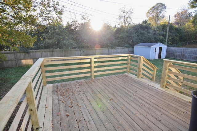 deck featuring a lawn and a storage unit