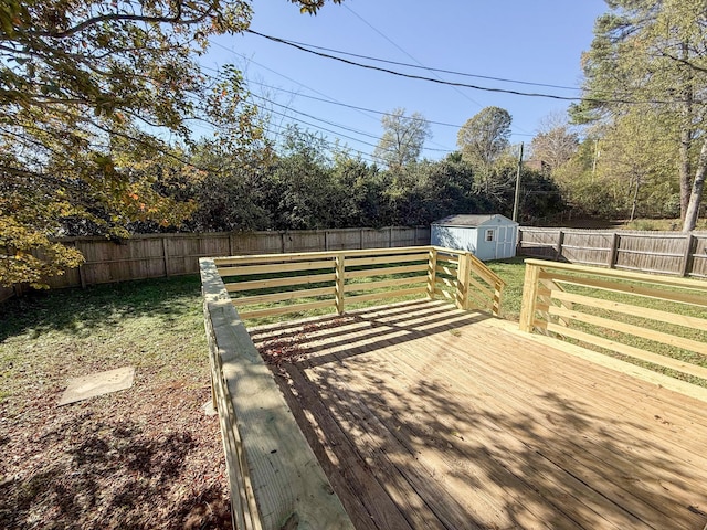 deck featuring a storage shed and a yard