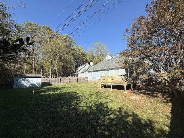 view of yard with a shed and a deck