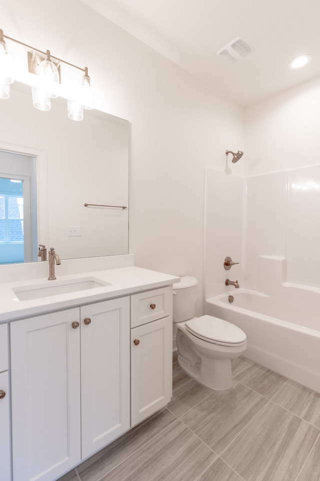 full bathroom with hardwood / wood-style floors, vanity, toilet, and bathing tub / shower combination